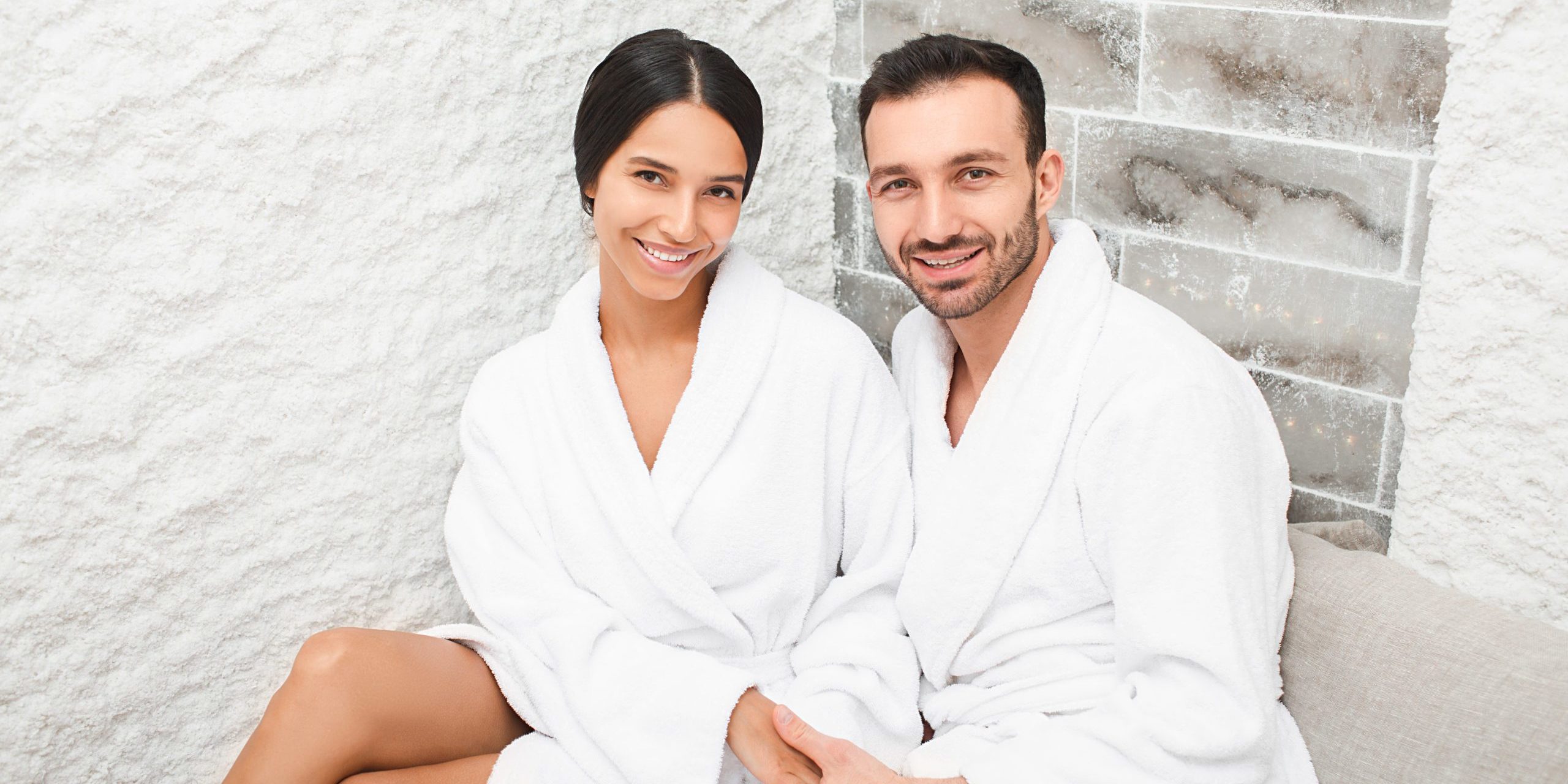 Portrait beautiful mixed race couple in a salt room at a spa salon