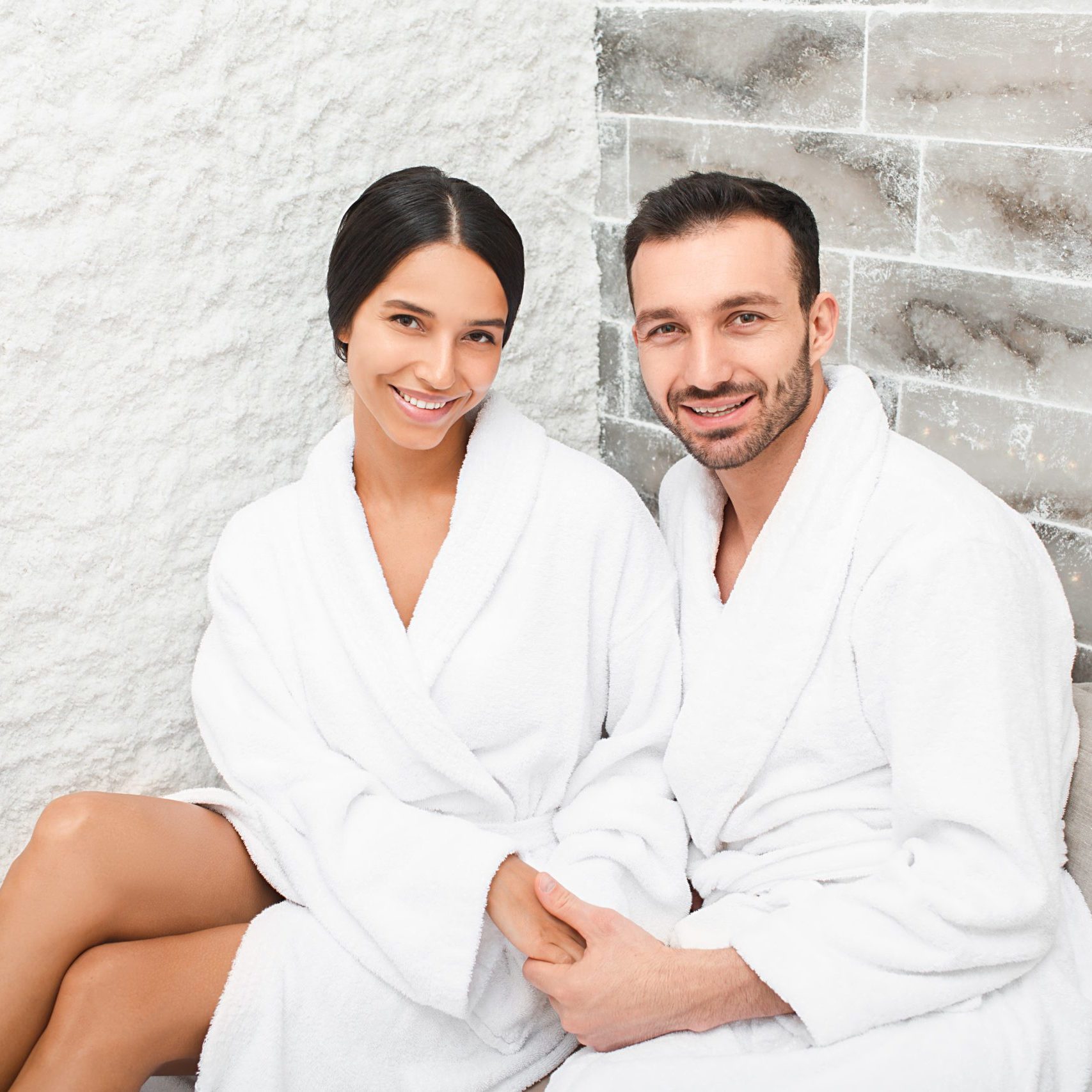 Portrait beautiful mixed race couple in a salt room at a spa salon